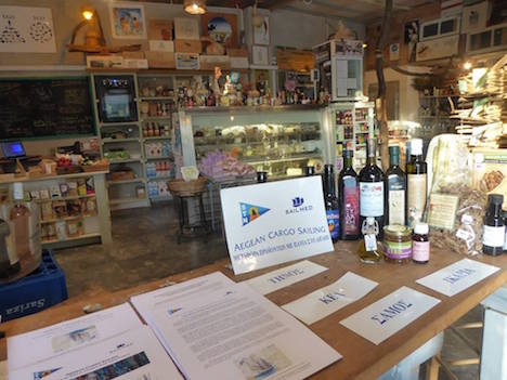 Andros Island shop display of sail transported goods, bilingual brochures