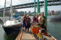 Part of the farm-bike-boat delivery team at last year’s Village Building Convergence on the dock at OMSI. 